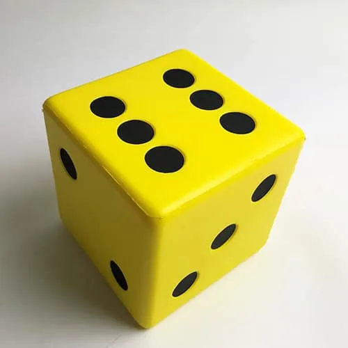A large yellow foam dice with big black dots.