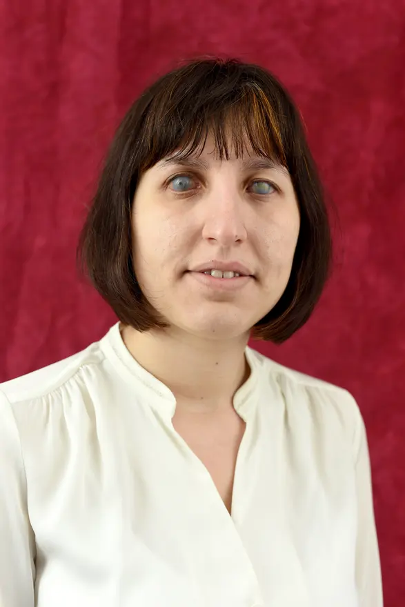 Elena Karamanska with a dark bob, wearing a cream blouse