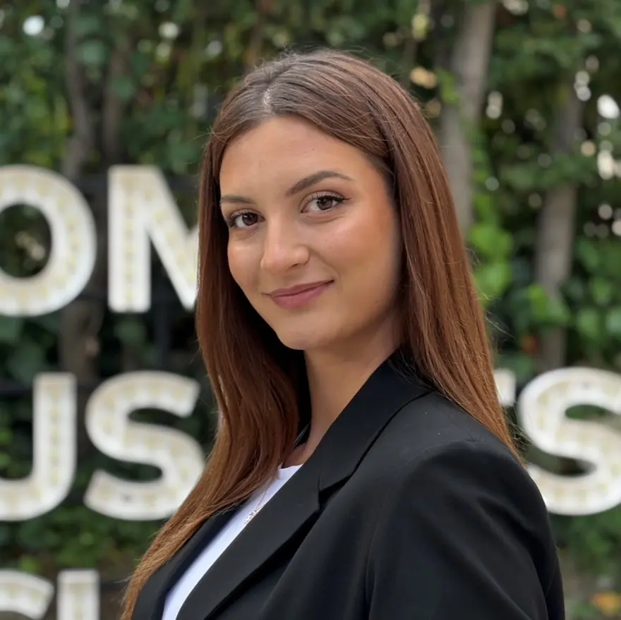 Katarina Stanisavljevic smiling in a black blazer, outdoors